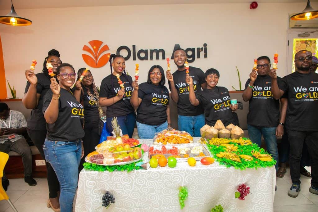 Olam Agri team celebrating workforce nutrition with healthy snacks and smiles.